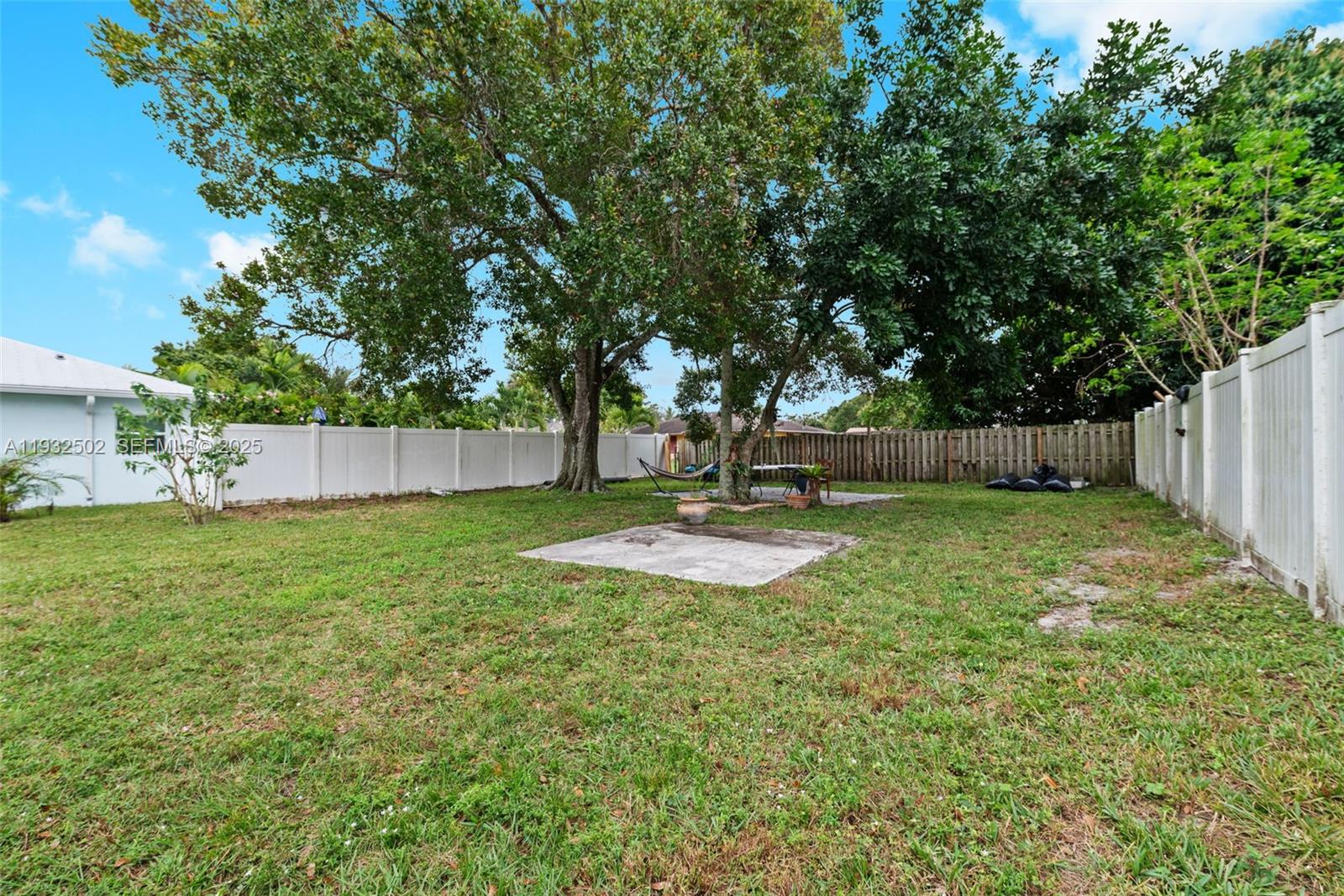 6894 3rd Street Jupiter, FL 33458 - Photo 25 of 29 a view of a backyard with large trees