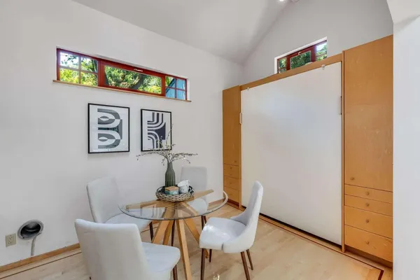 a view of a dining room with furniture and wooden floor