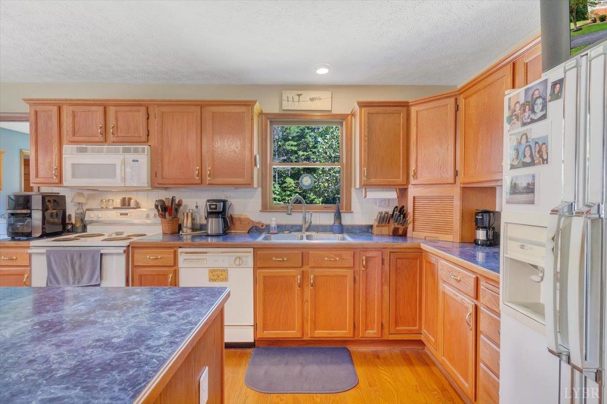 737 Homeplace Road Rustburg, VA 24588 - Photo 16 of 73 a kitchen with stainless steel appliances granite countertop a stove a sink and a microwave