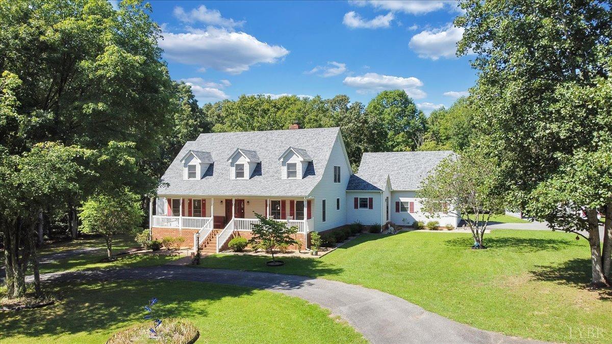 737 Homeplace Road Rustburg, VA 24588 - Photo 2 of 73 a view of a white house with a big yard plants and large trees