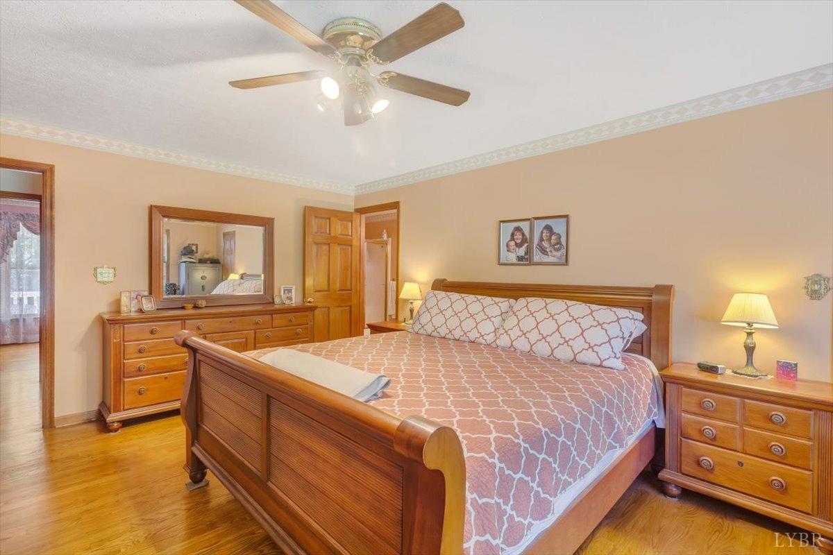 737 Homeplace Road Rustburg, VA 24588 - Photo 21 of 73 a bedroom with a bed and a chandelier