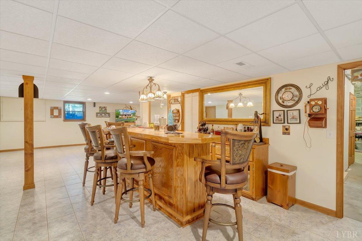 737 Homeplace Road Rustburg, VA 24588 - Photo 35 of 73 a dining room with furniture and a clock