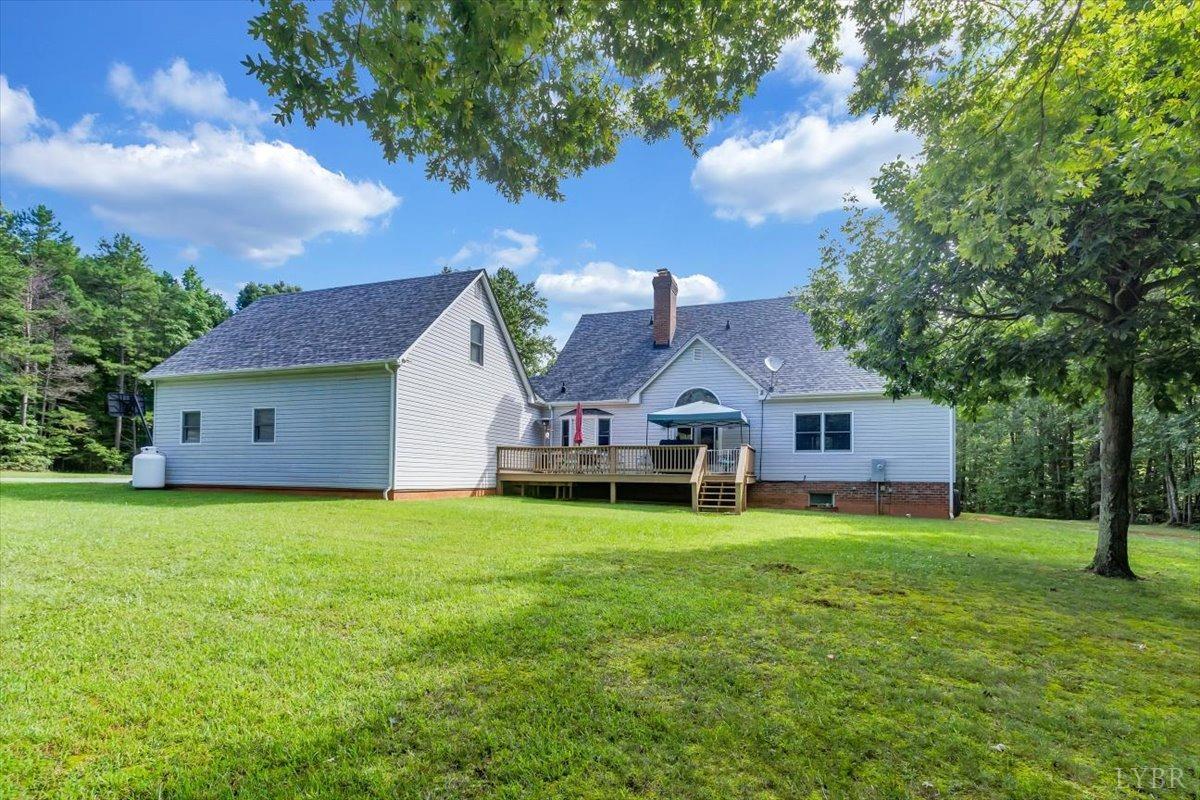 737 Homeplace Road Rustburg, VA 24588 - Photo 47 of 73 a house that is sitting in the grass with large trees and plants