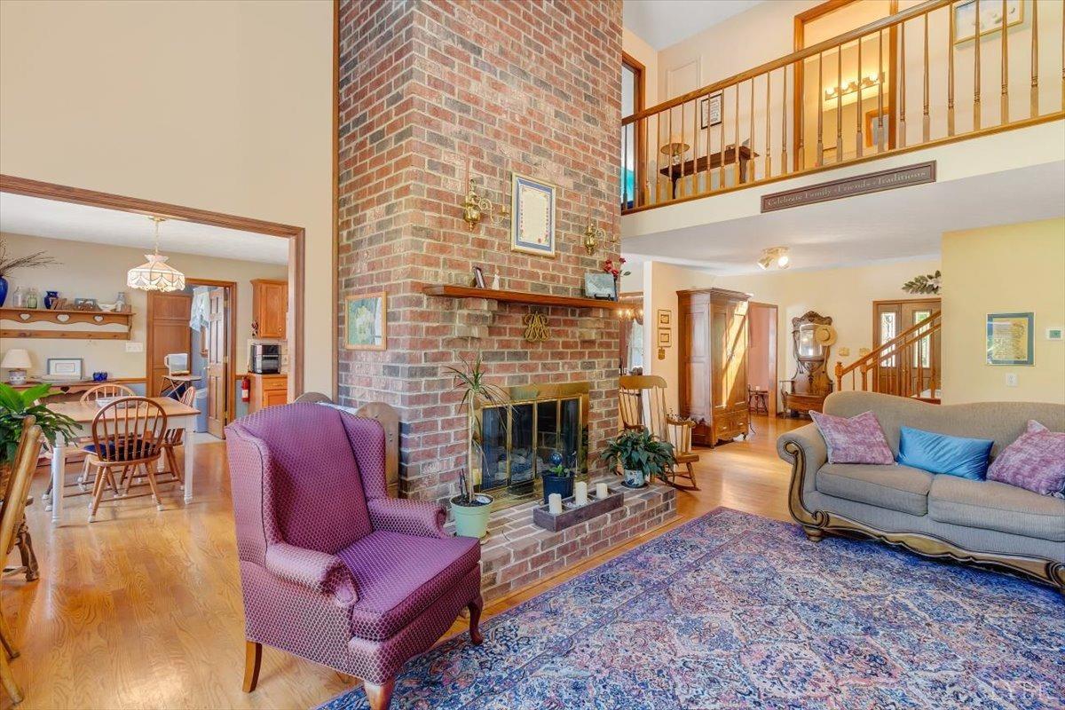 737 Homeplace Road Rustburg, VA 24588 - Photo 5 of 73 a living room with furniture a fireplace and a dining table