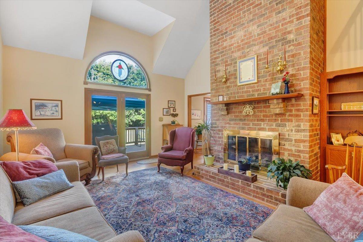 737 Homeplace Road Rustburg, VA 24588 - Photo 7 of 73 a living room with furniture a fireplace and a large window