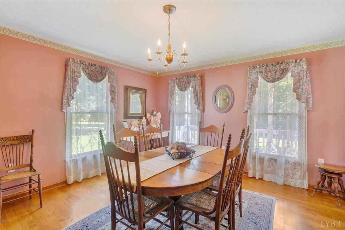 737 Homeplace Road Rustburg, VA 24588 - Photo 9 of 73 a view of a dining room with furniture window and wooden floor
