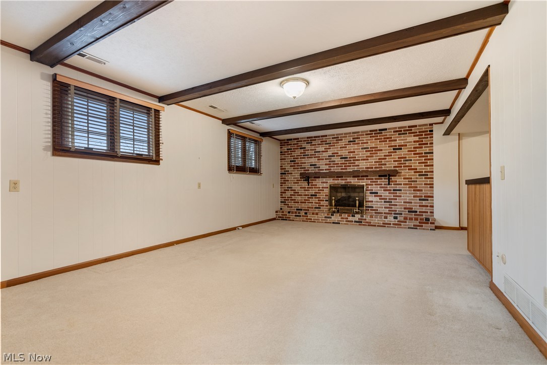 2240 Devonshire Road Northwest Canton, OH 44708 - Photo 27 of 36 The lower level offers this fantastic family room with fireplace wall.