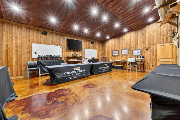 a view of a living room with a tv and wooden floor