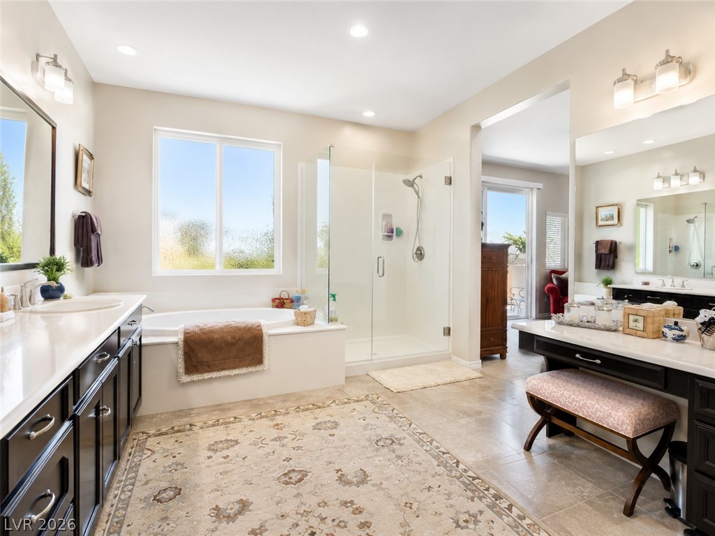 9724 University Ridge Avenue Las Vegas, NV 89149 - Photo 49 of 61 Luxurious bathing quarters with dual vanities and a deep soaking tub, perfect for unwinding.