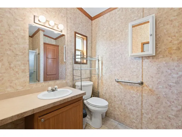 a bathroom with a sink a toilet a mirror and shower