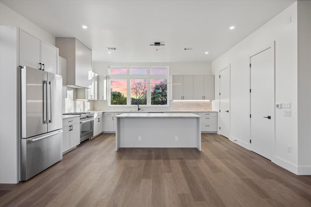 4101 Menchaca Road, Unit 102 Austin, TX 78704 - Photo 4 of 14 Culinary dreams come alive in this kitchen, featuring an oversized island and quality stainless steel appliances.