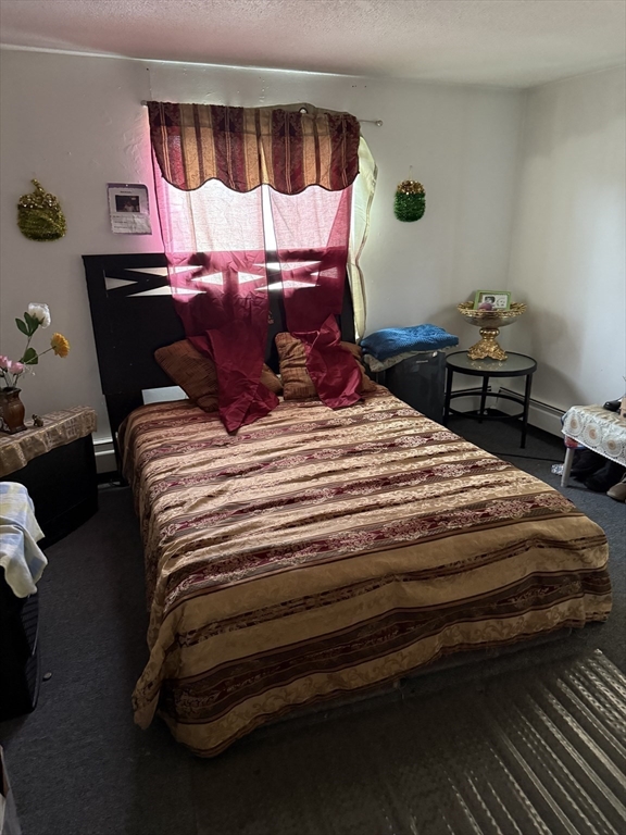 16 A Exeter Street Lawrence, MA 01843 - Photo 7 of 12 a bedroom with a bed and a window