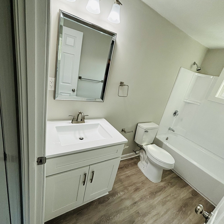 16 A Exeter Street Lawrence, MA 01843 - Photo 8 of 12 a bathroom with a sink toilet vanity and mirror