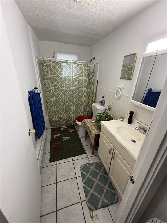 16 A Exeter Street Lawrence, MA 01843 - Photo 9 of 12 a living room with a couch and a floor to ceiling window