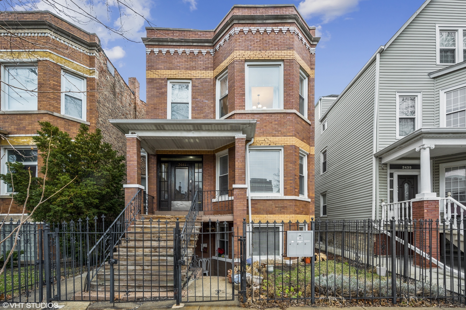 2441 North Avers Avenue Chicago, IL 60647 - Photo 1 of 28 front view of a brick house with a clock on the wall