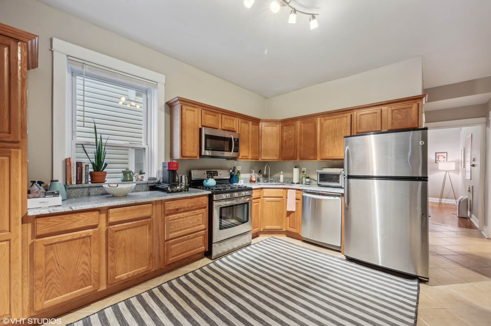 2441 North Avers Avenue Chicago, IL 60647 - Photo 12 of 28 a kitchen with granite countertop stainless steel appliances a refrigerator sink and cabinets
