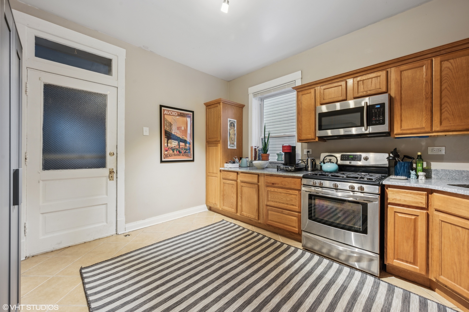2441 North Avers Avenue Chicago, IL 60647 - Photo 13 of 28 a kitchen with stainless steel appliances granite countertop a stove and cabinets