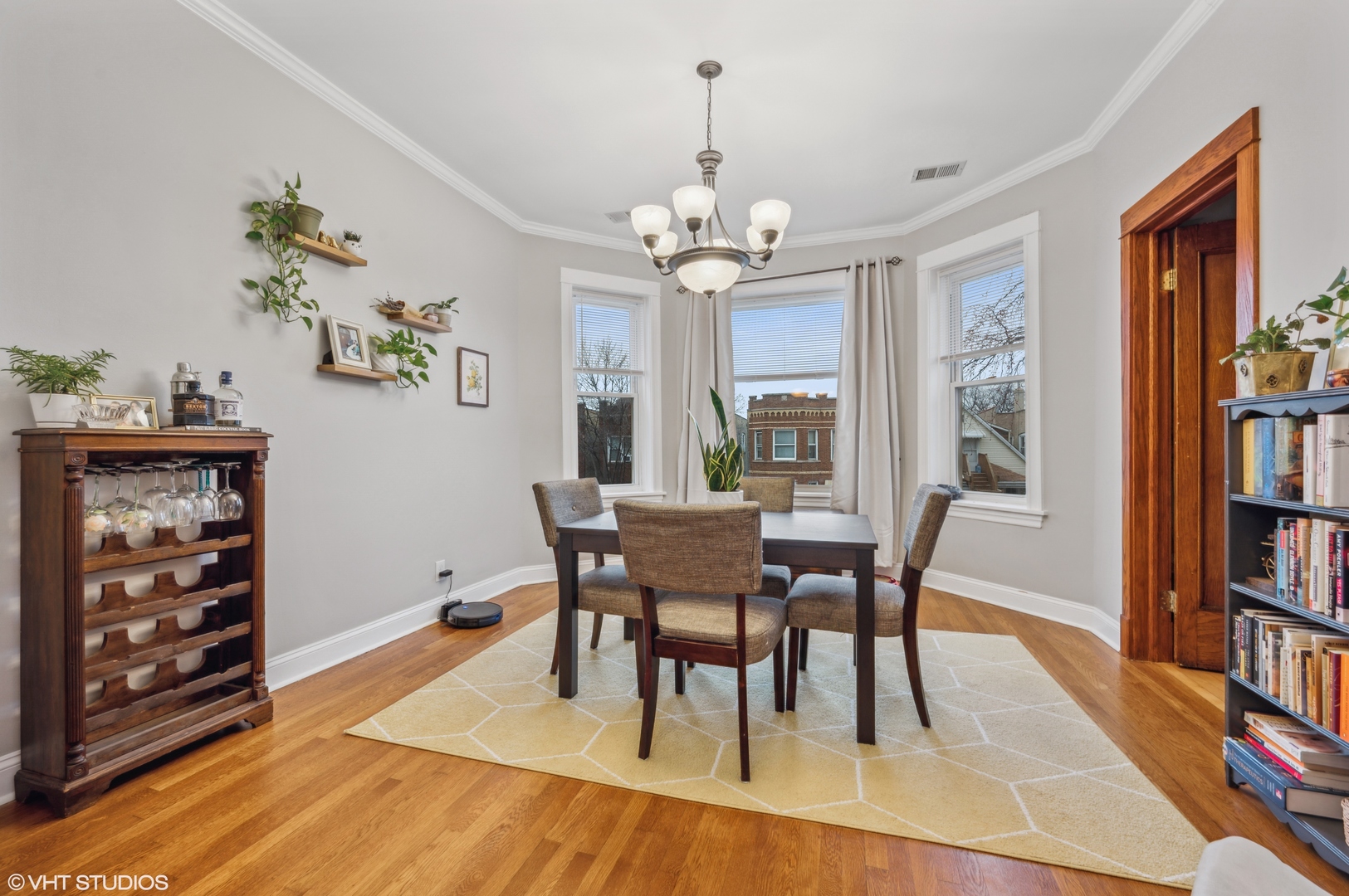 2441 North Avers Avenue Chicago, IL 60647 - Photo 15 of 28 a dining room with furniture a book and wooden floor