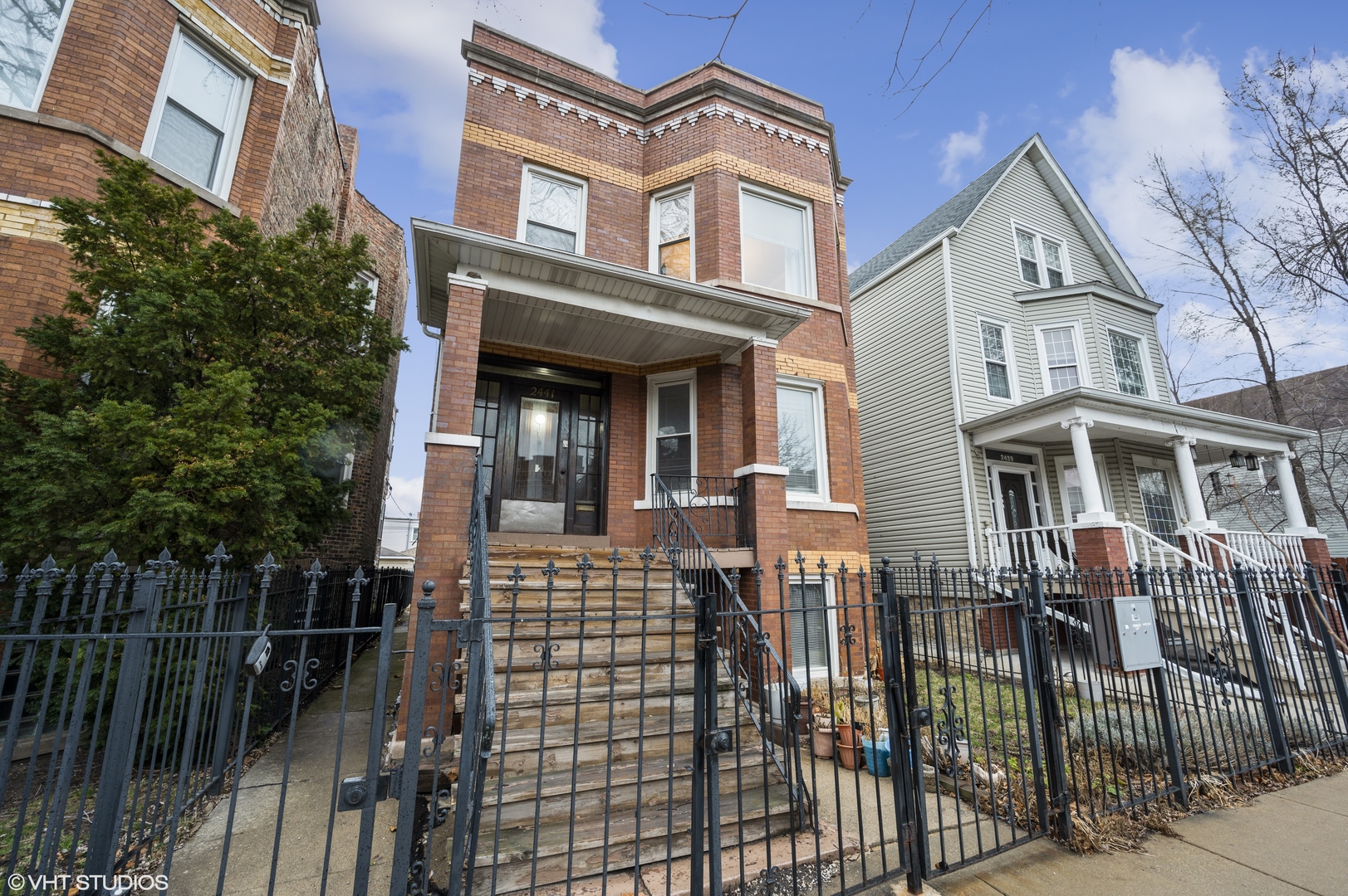 2441 North Avers Avenue Chicago, IL 60647 - Photo 2 of 28 a front view of a house with glass windows and brick walls