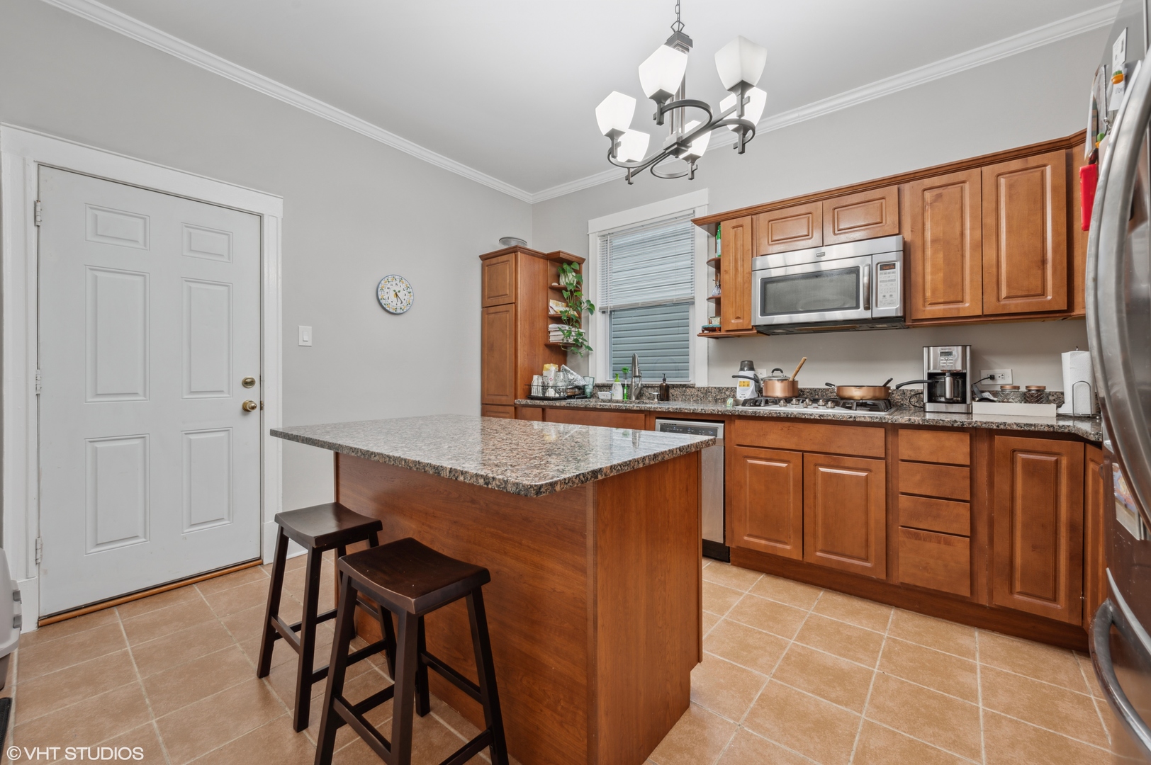 2441 North Avers Avenue Chicago, IL 60647 - Photo 24 of 28 a kitchen with stainless steel appliances granite countertop a sink counter space cabinets and a window
