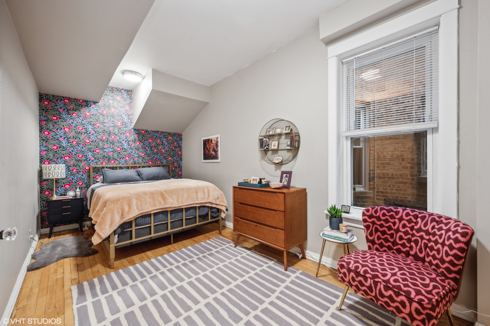 2441 North Avers Avenue Chicago, IL 60647 - Photo 8 of 28 a bed sitting in a bedroom next to a window with a dresser and paintings on the wall