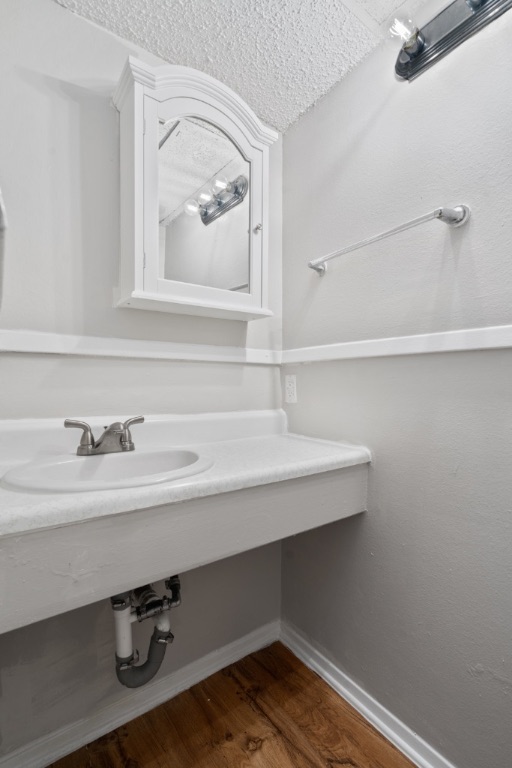 4103 Speedway, Unit 105 Austin, TX 78751 - Photo 10 of 10 Bathroom featuring a textured ceiling and dark wood-style floors