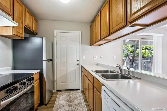 a kitchen that has a sink and a stove