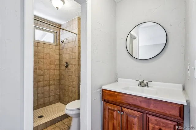 a bathroom with a sink a toilet and a mirror