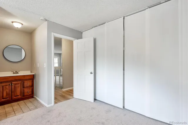 a view of a kitchen with cabinets and wooden floor