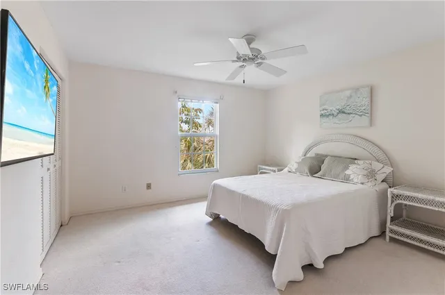 a bedroom with a bed and painting on the wall