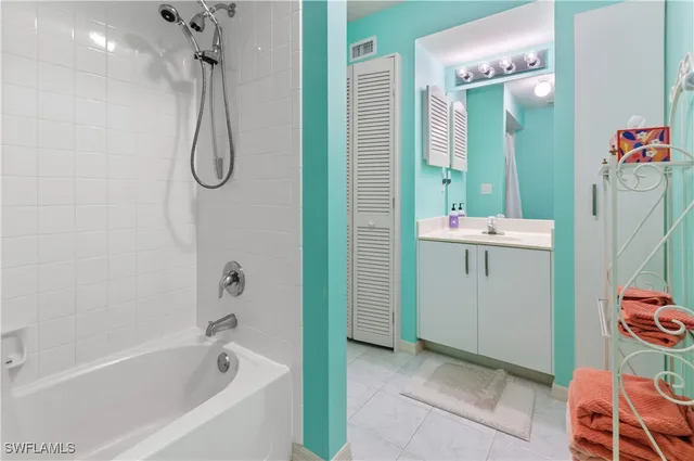 a bathroom with a bath tub a sink and a shower