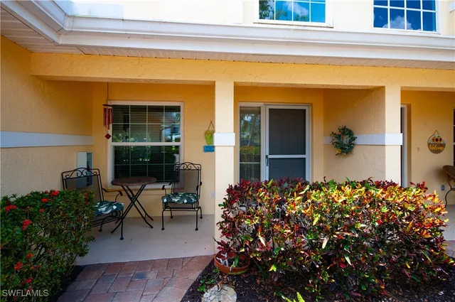 a couple of flower plants in front of a house