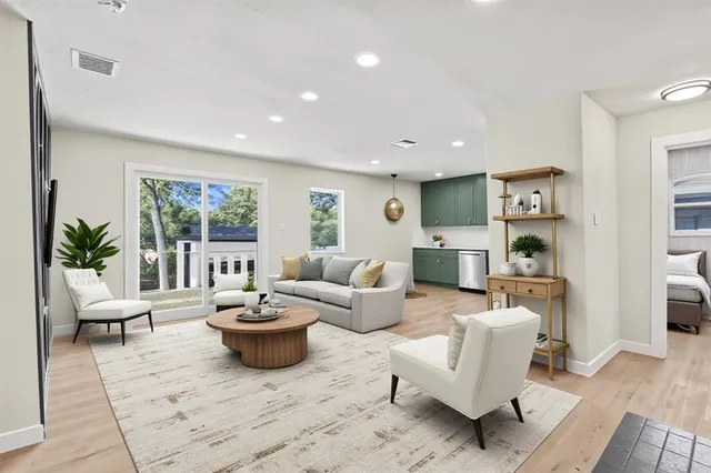 a living room with furniture potted plant and a window