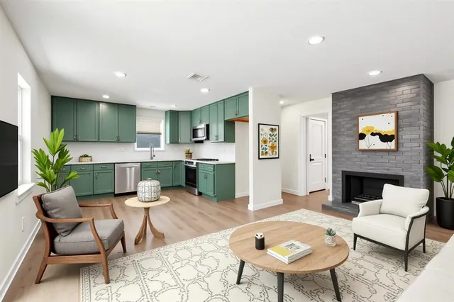 a living room with furniture and a kitchen view
