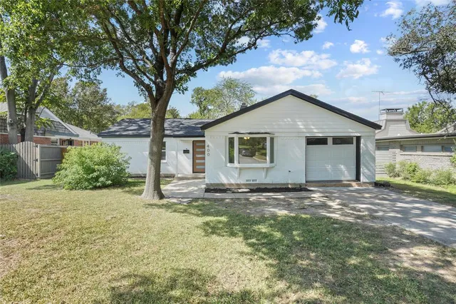 a big house with a big yard and large trees