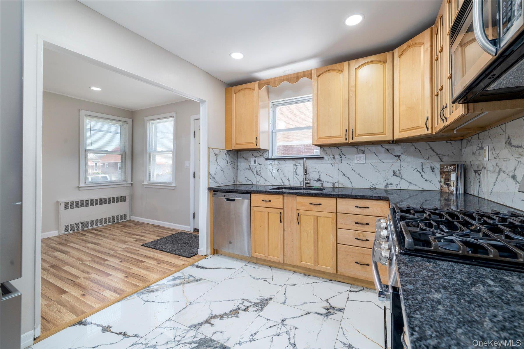 191 Raff Avenue Mineola, NY 11501 - Photo 15 of 25 a kitchen with stainless steel appliances granite countertop a stove a sink and a microwave
