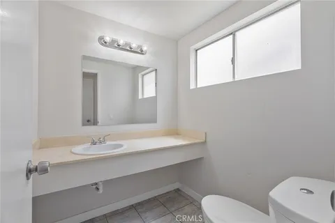 a bathroom with a sink a toilet and mirror