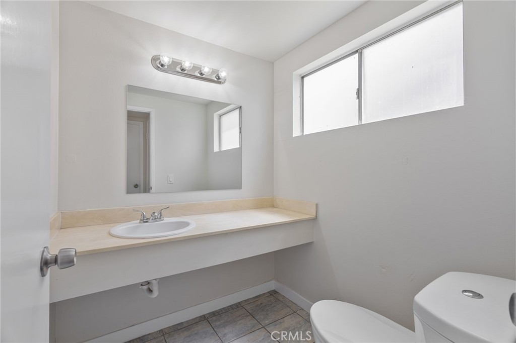 1708 East Cyrene Drive Carson, CA 90746 - Photo 13 of 26 a bathroom with a sink a toilet and mirror