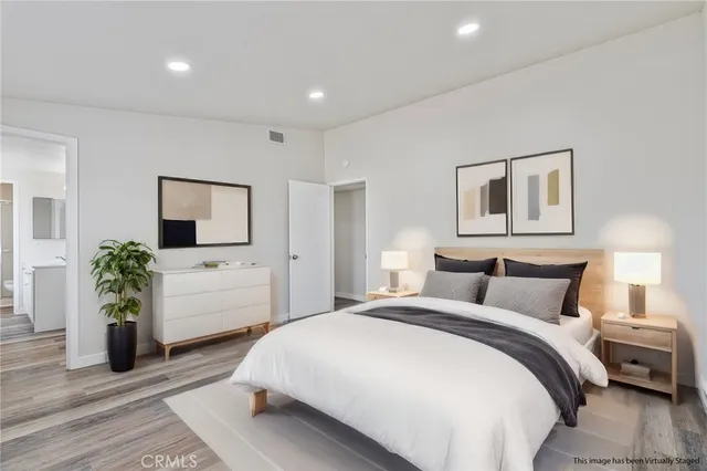 a bedroom with a large bed and a flat screen tv