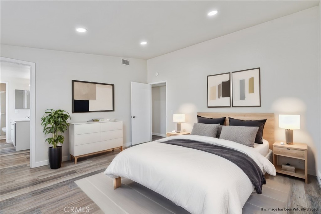 1708 East Cyrene Drive Carson, CA 90746 - Photo 14 of 26 a bedroom with a large bed and a flat screen tv