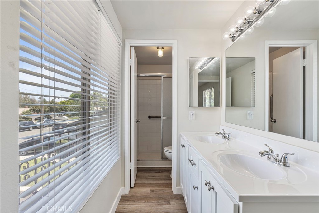 1708 East Cyrene Drive Carson, CA 90746 - Photo 16 of 26 a spacious bathroom with a double vanity sink a mirror and a shower