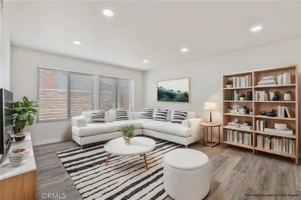 a living room with furniture and a book shelf