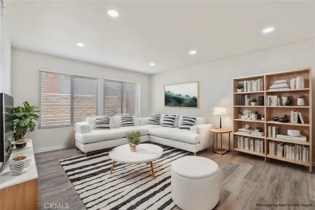 a living room with furniture and a book shelf