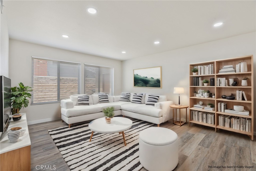 1708 East Cyrene Drive Carson, CA 90746 - Photo 3 of 26 a living room with furniture and a book shelf