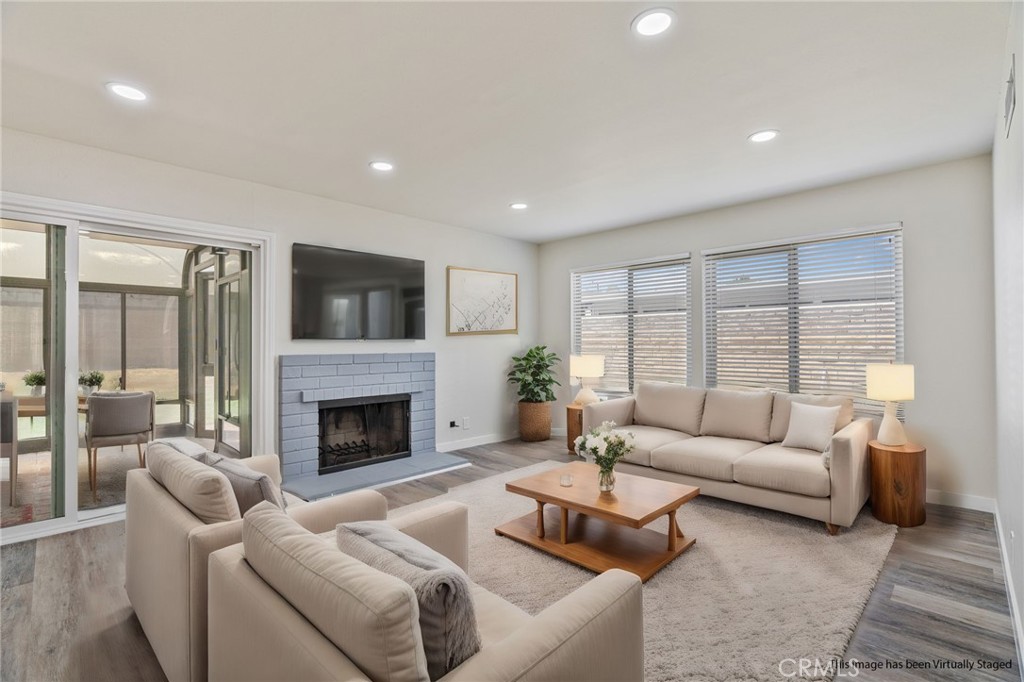 1708 East Cyrene Drive Carson, CA 90746 - Photo 4 of 26 a living room with furniture and a fireplace