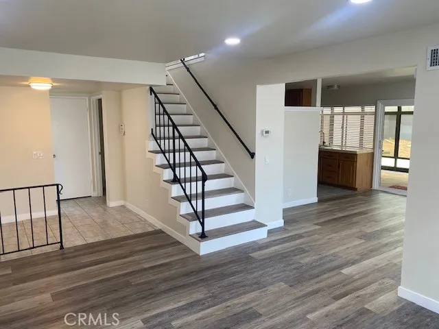 a view of entryway and hall with wooden floor