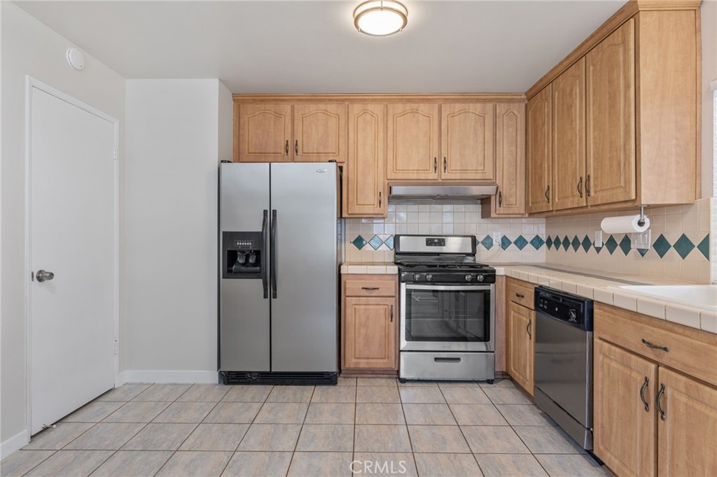 1708 East Cyrene Drive Carson, CA 90746 - Photo 8 of 26 a kitchen with a stove top oven and cabinets