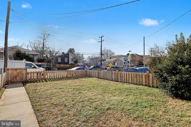 a view of a house with a wooden fence