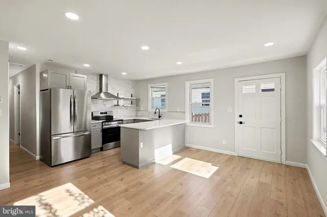 a large kitchen with a lot of counter space and stainless steel appliances