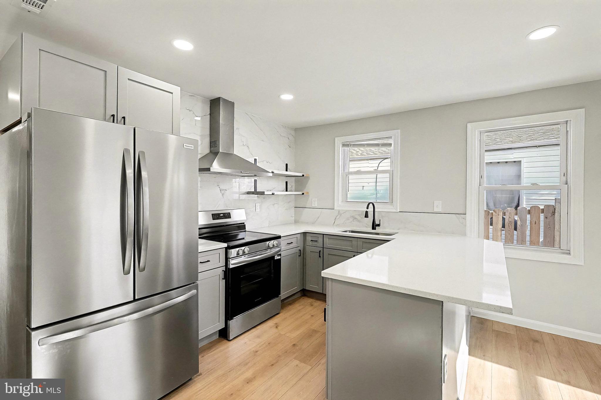 40 East Reed Avenue Alexandria, VA 22305 - Photo 5 of 19 a kitchen with stainless steel appliances granite countertop a refrigerator a stove a sink and a refrigerator